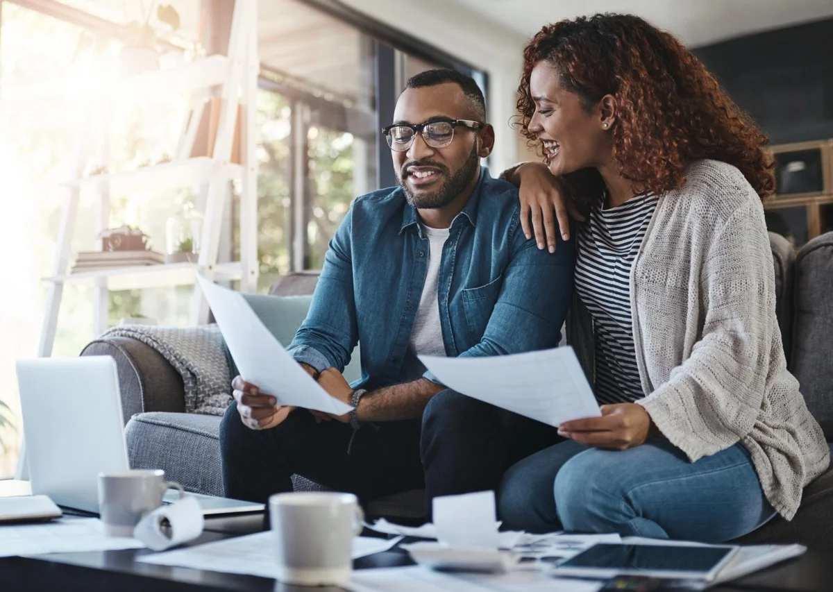 California homeowners reviewing refinance options and documents together at home